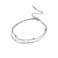 Modernes Feder‑Armband mit doppelter Kette und farbigem Band