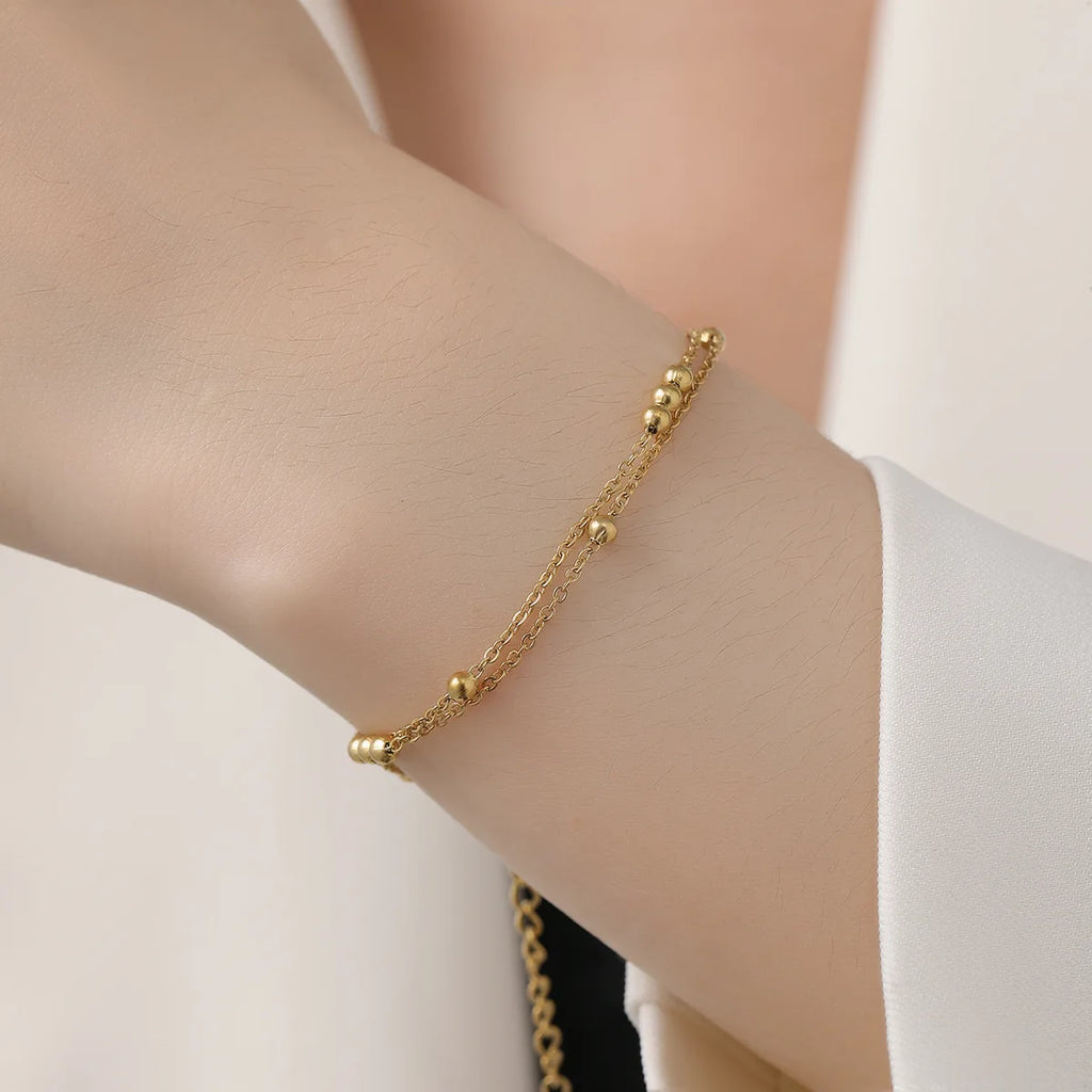 Vergoldete Doppelreihen‑Perlenarmband mit kleinen Rundperlen